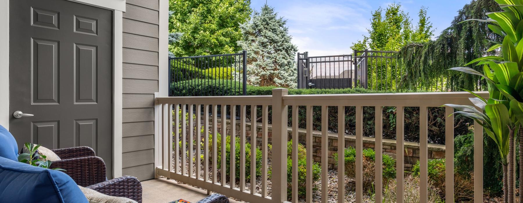 a deck with seating and trees in the background