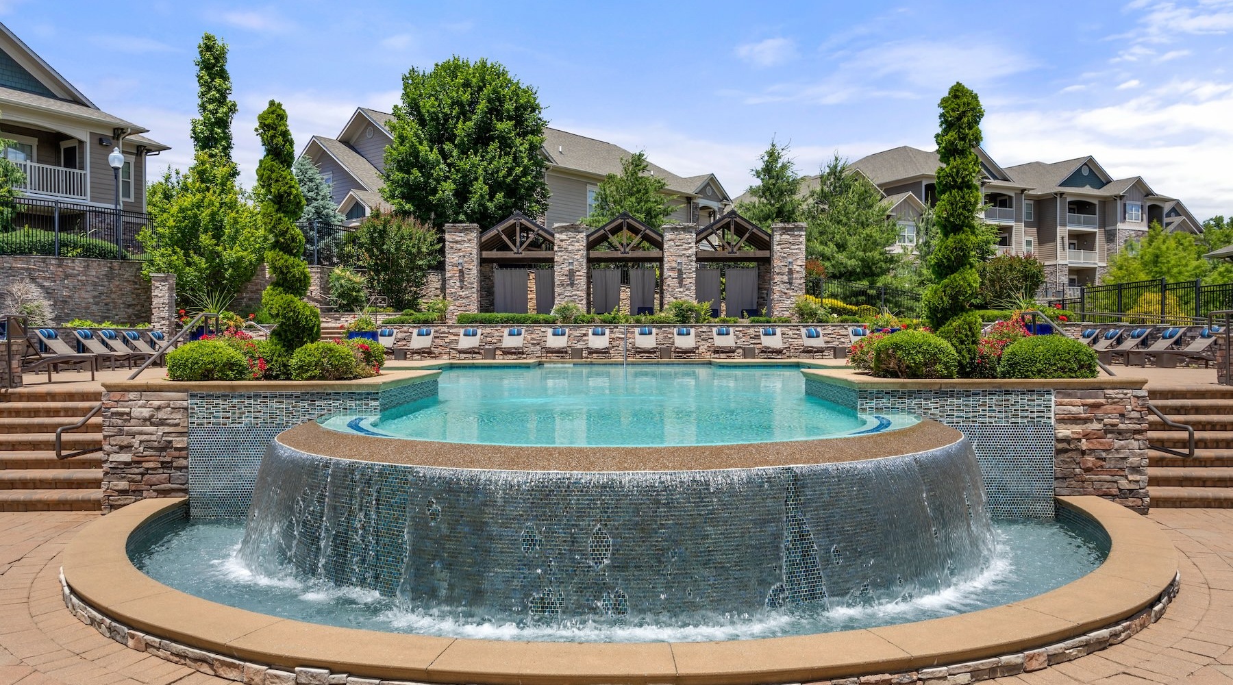 a fountain of water with a building behind it