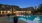 resort style pool with a building behind it at dusk